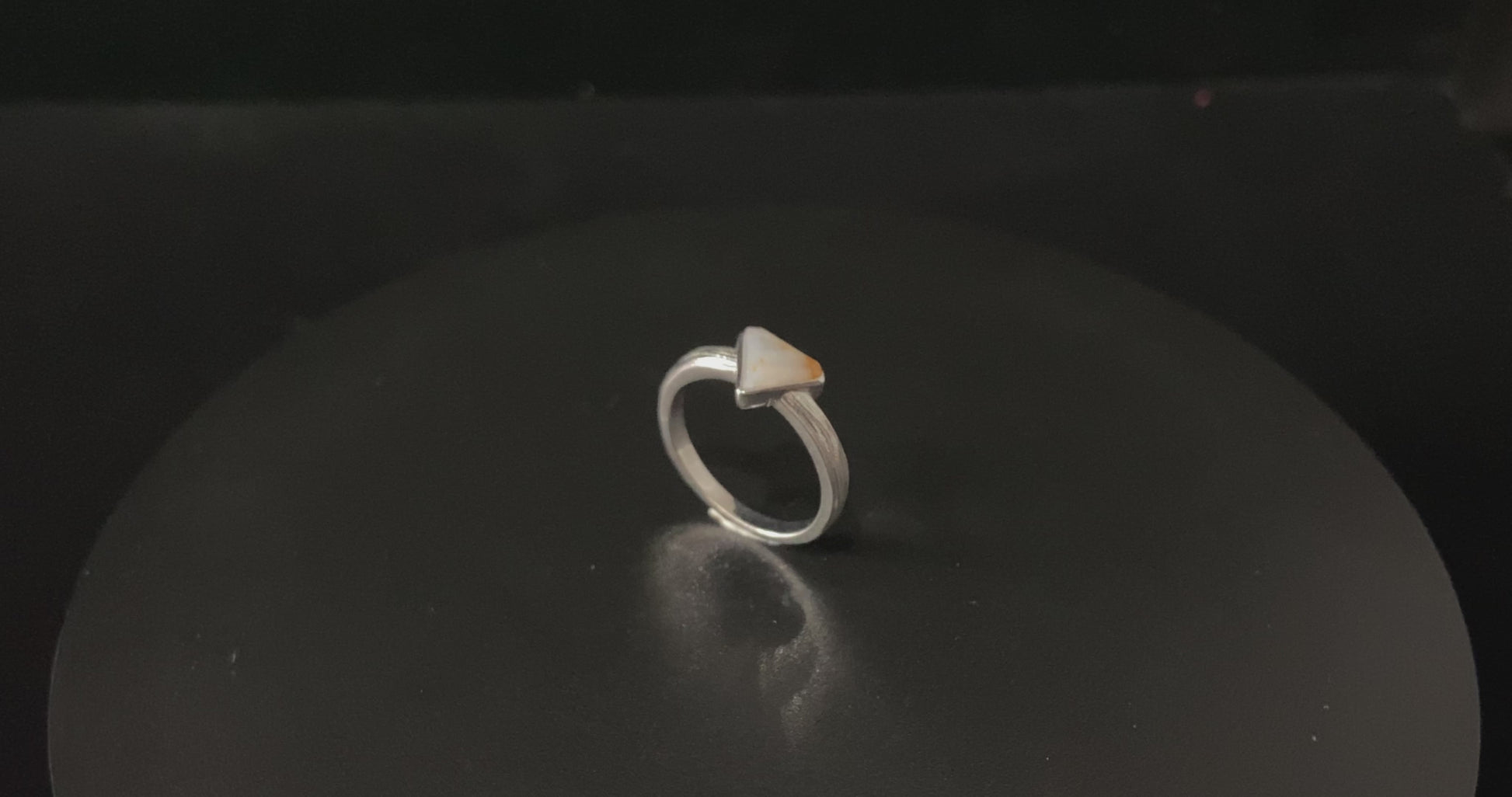 A sunset sugar triangle jadeite ring.