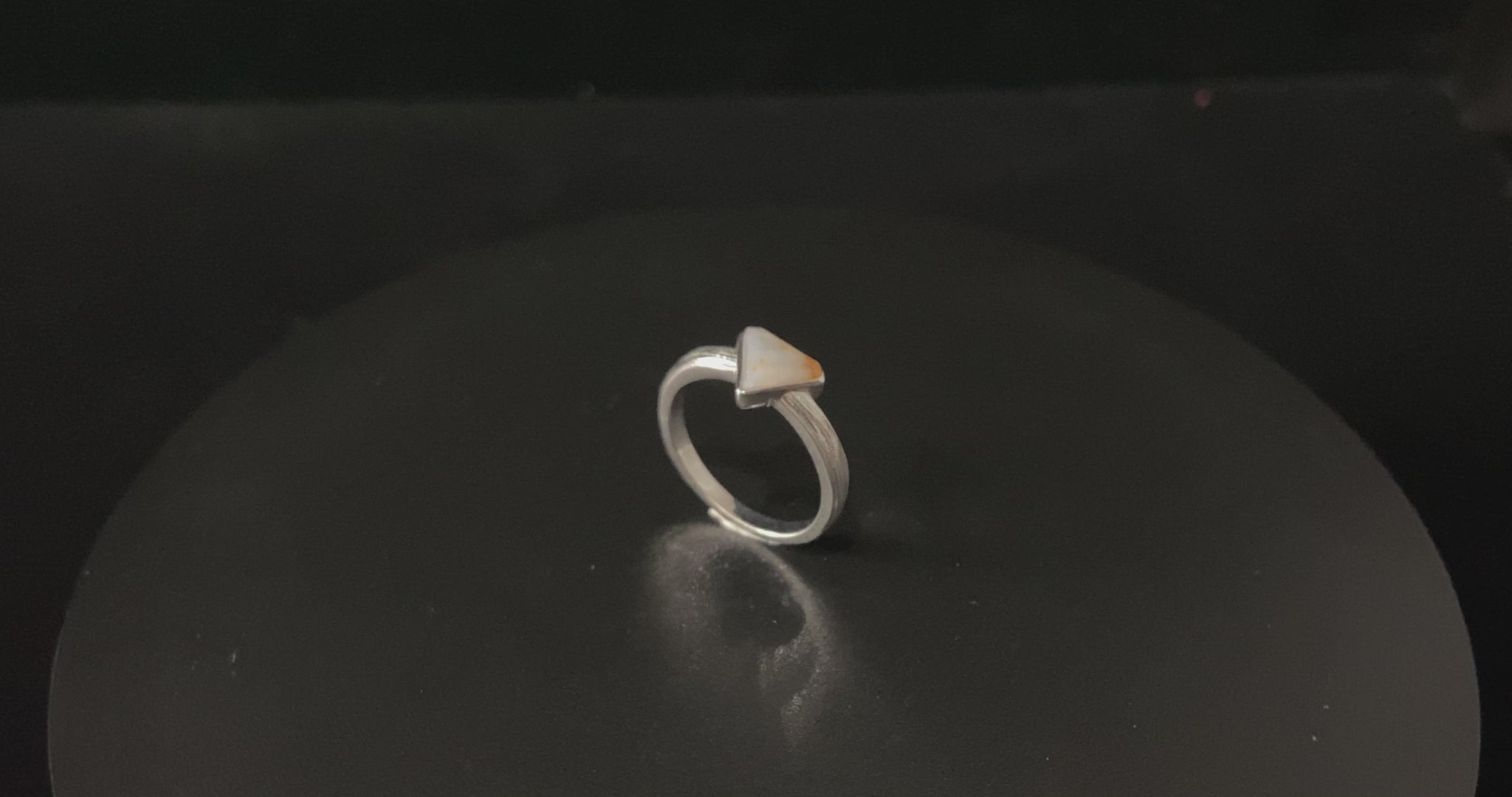 A sunset sugar triangle jadeite ring.