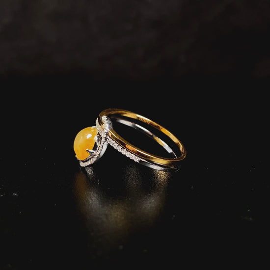 A yellow interlock star halo jadeite ring.