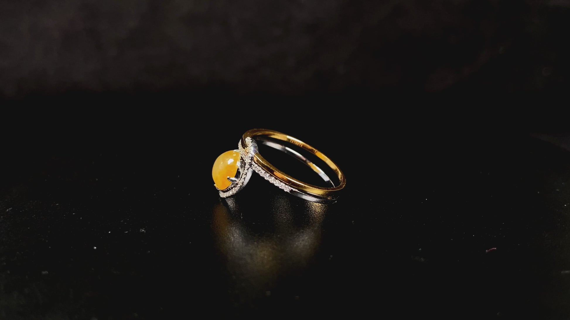 A yellow interlock star halo jadeite ring.