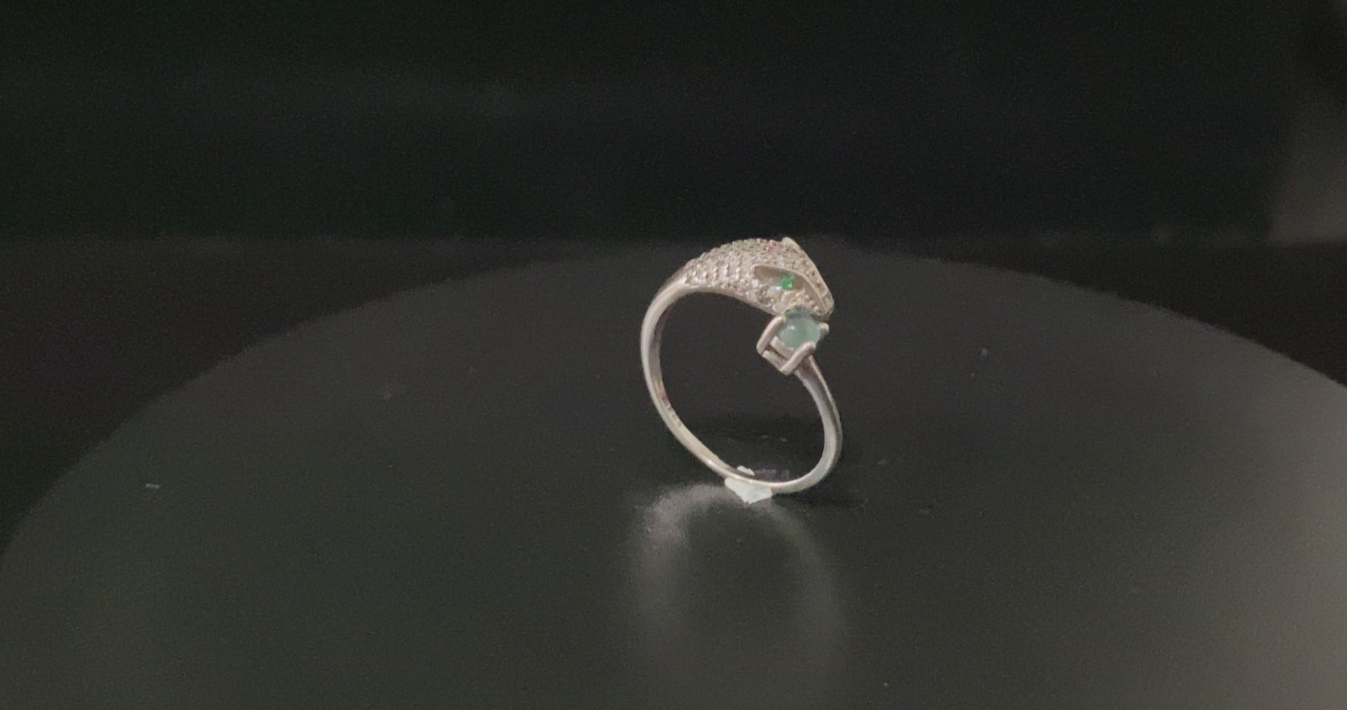 A silver serpent bite jadeite ring.