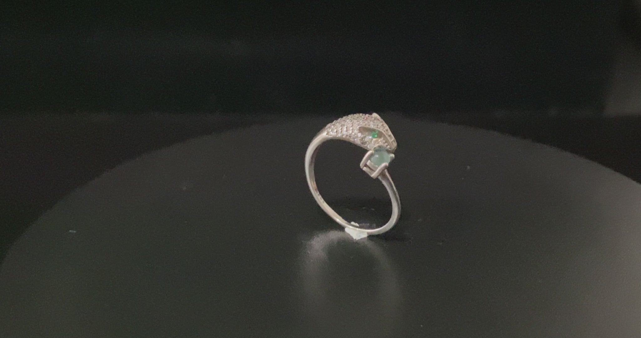 A silver serpent bite jadeite ring.