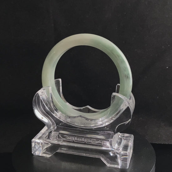 A milky white with faint green jadeite bangle.