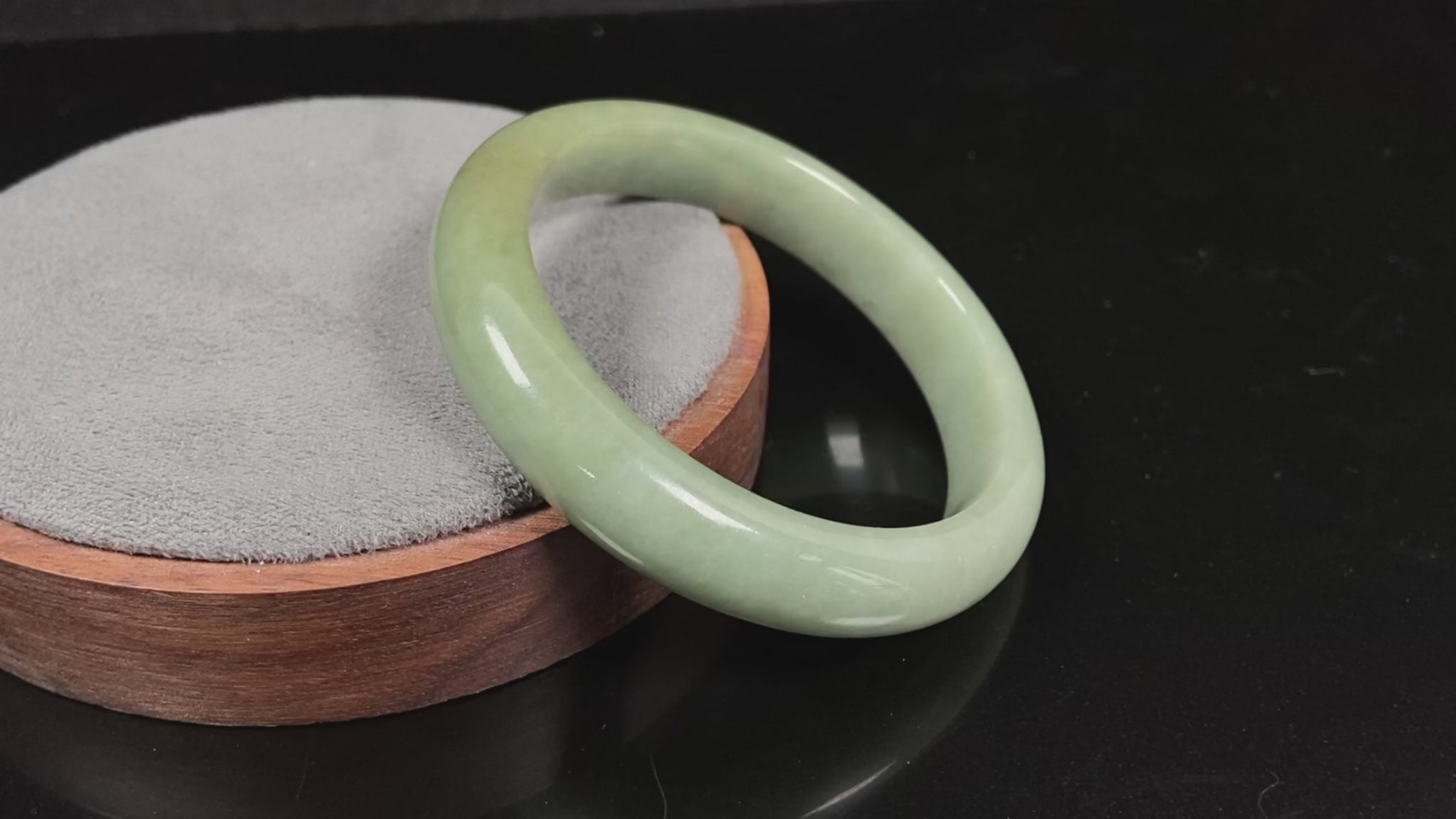 A light green base with warm golden hues jadeite bangle.