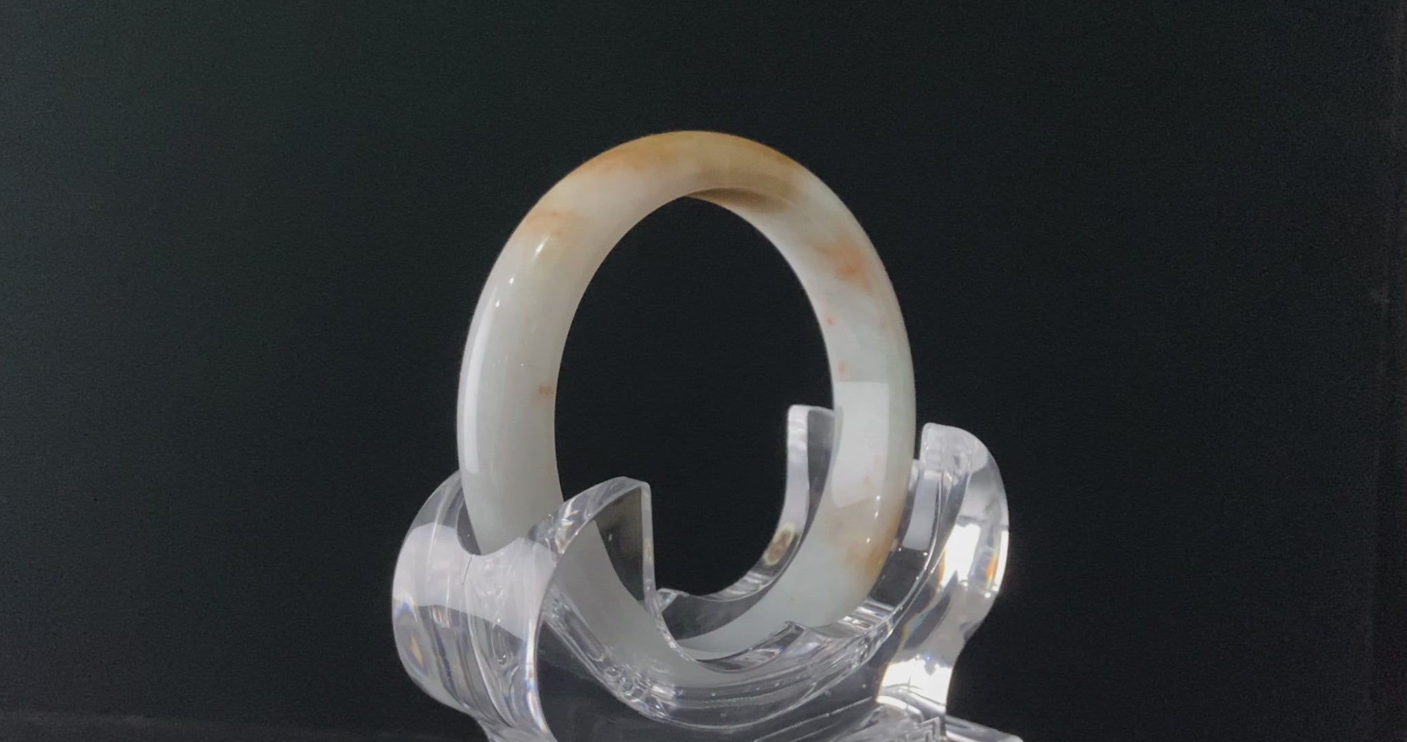 A amber dawn vein jadeite bangle.