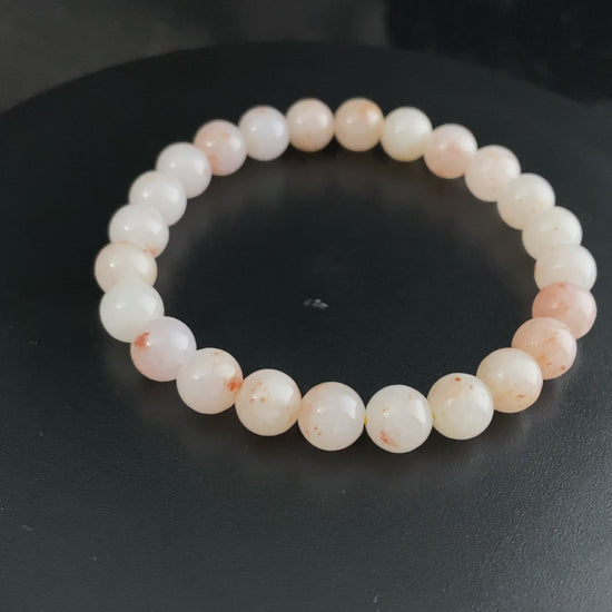 A warm peach tone jadeite beads bracelet.