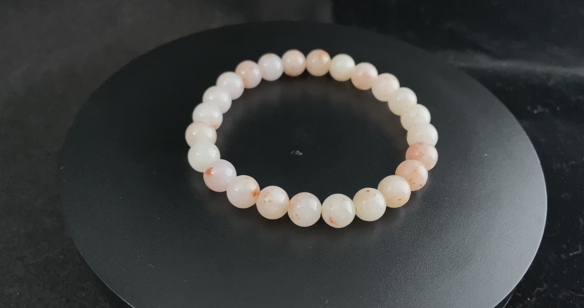 A warm peach tone jadeite beads bracelet.