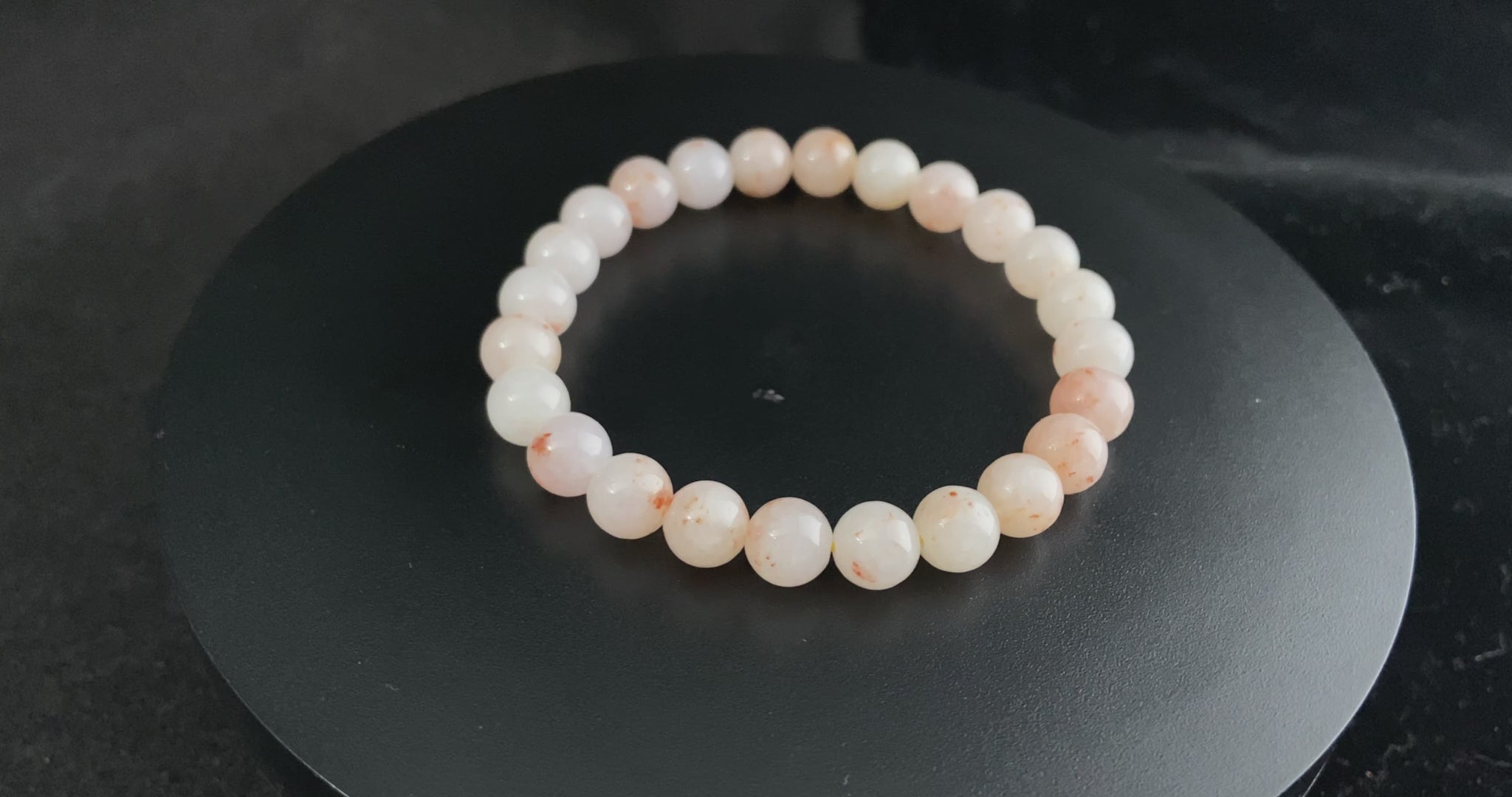A warm peach tone jadeite beads bracelet.