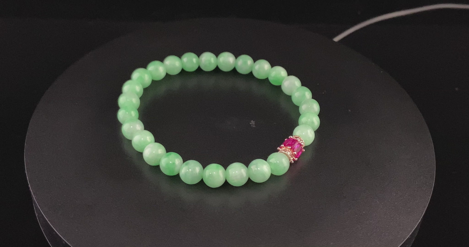 A pale mint and pink spark jadeite beads bracelet.