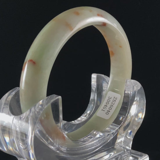 A moss coral calm jadeite bangle.
