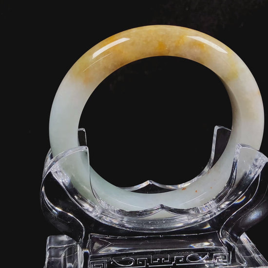 A creamy white with green and honey yellow  jadeite bangle.