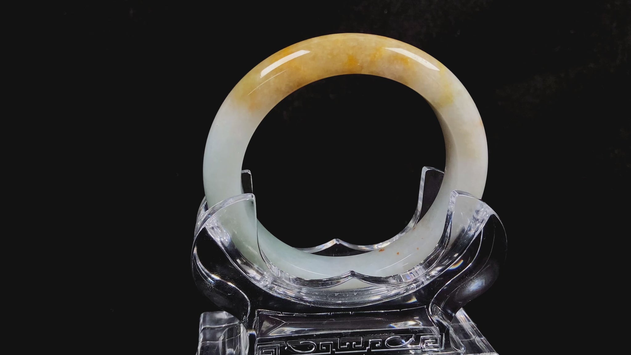 A creamy white with green and honey yellow  jadeite bangle.