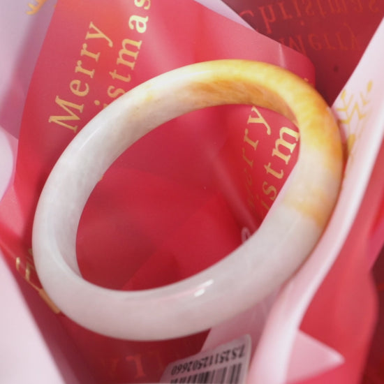 A ivory base with warm amber accent  jadeite bangle.