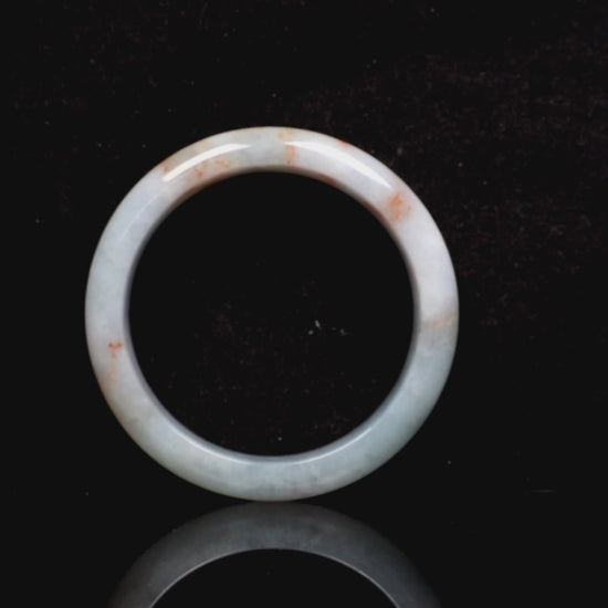 A coral glow veil jadeite bangle.