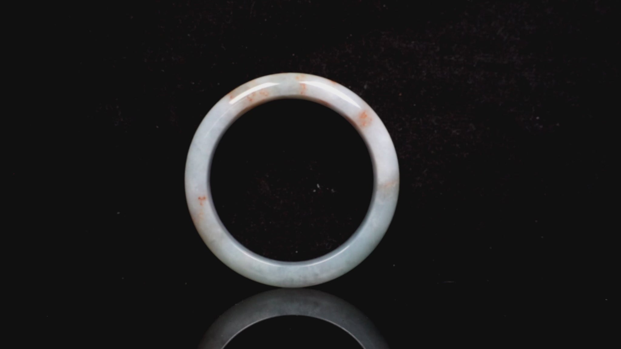 A coral glow veil jadeite bangle.