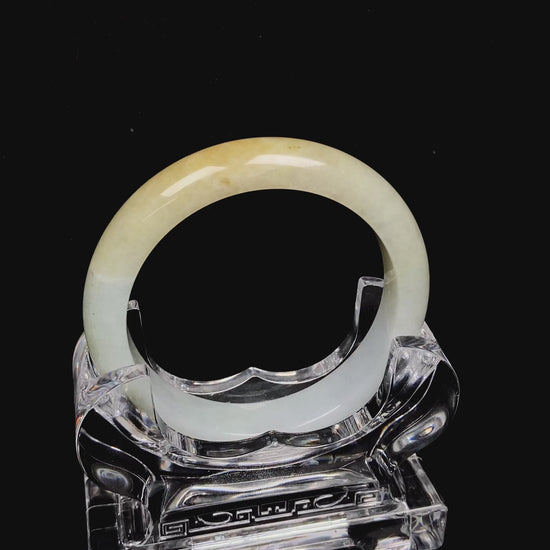 A creamy gold veil jadeite bangle.