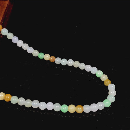 A soft glossy tri-color jadeite beads necklace.