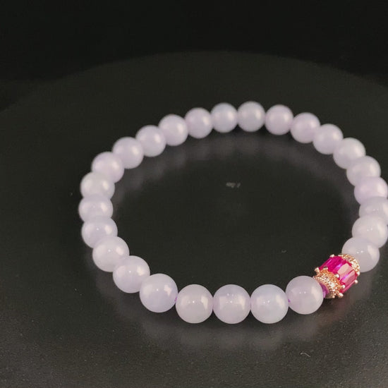 A clear white with pink thread jadeite beads bracelet.