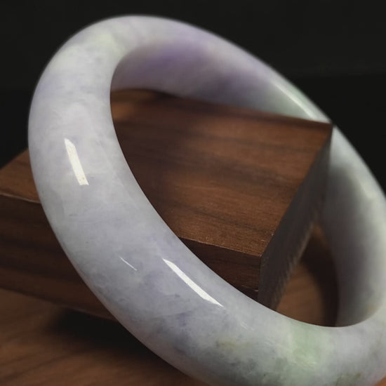 A pale lavender purple base with gentle green accents jadeite bangle.