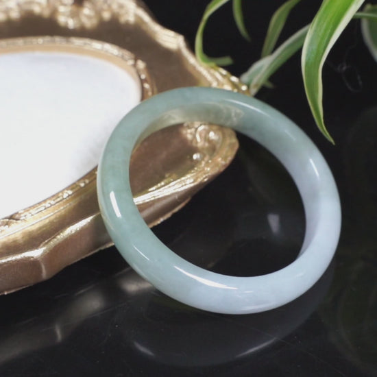 A half white half pale green dual tone  jadeite bangle.