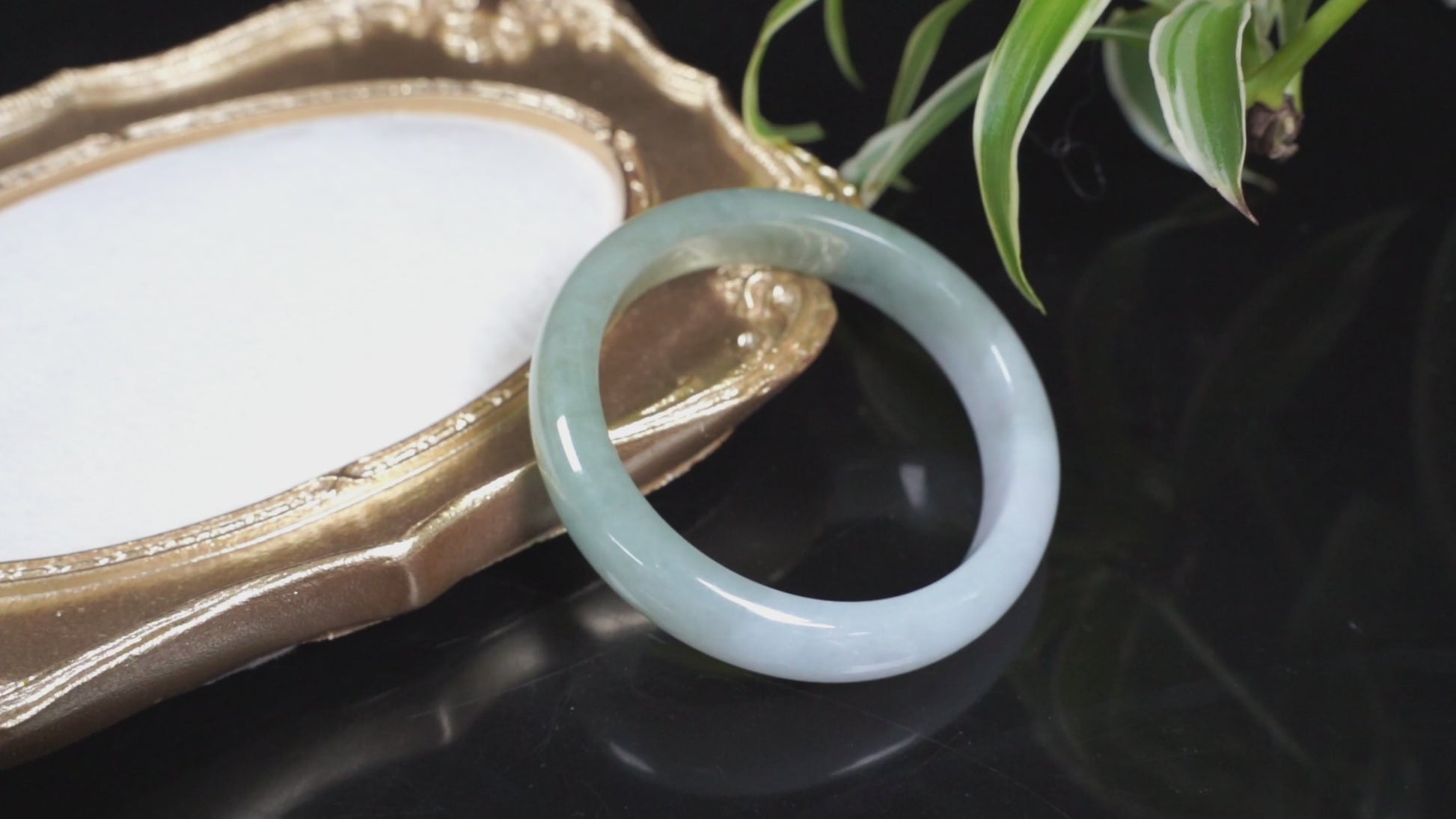 A half white half pale green dual tone  jadeite bangle.