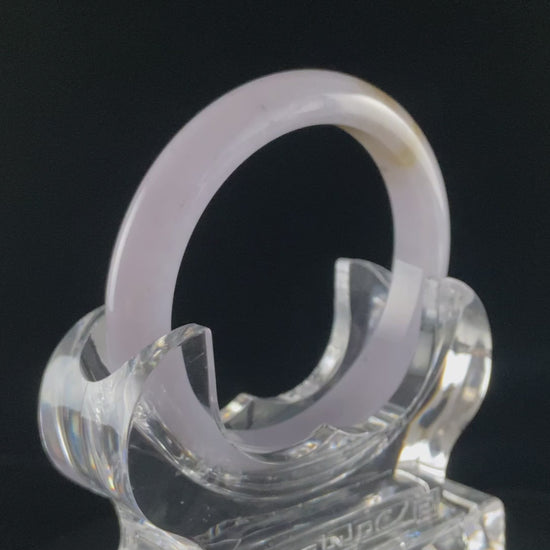 A lavender golden tip jadeite bangle.