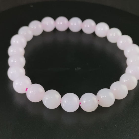A clear white with pink thread jadeite beads bracelet.