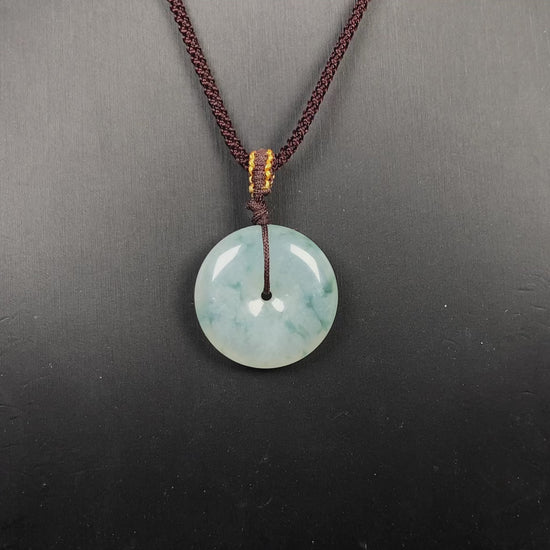 A blue green Ping An Kou jadeite pendant.