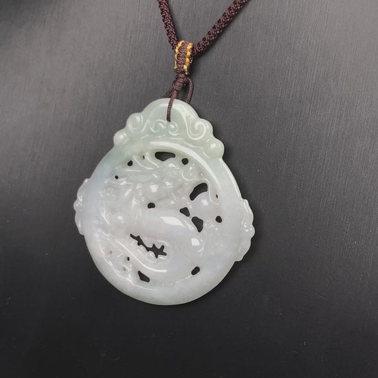 A pale green hollow dragon jadeite pendant.