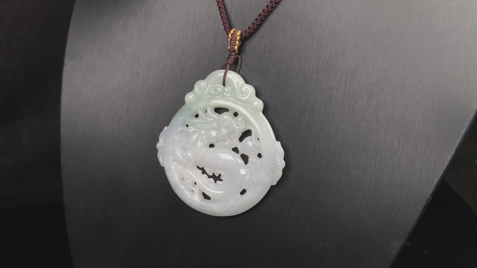 A pale green hollow dragon jadeite pendant.
