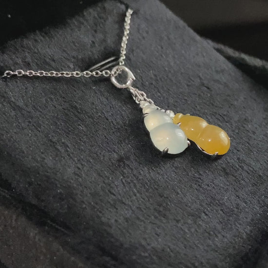 A sun and moon twin gourds jadeite pendant.