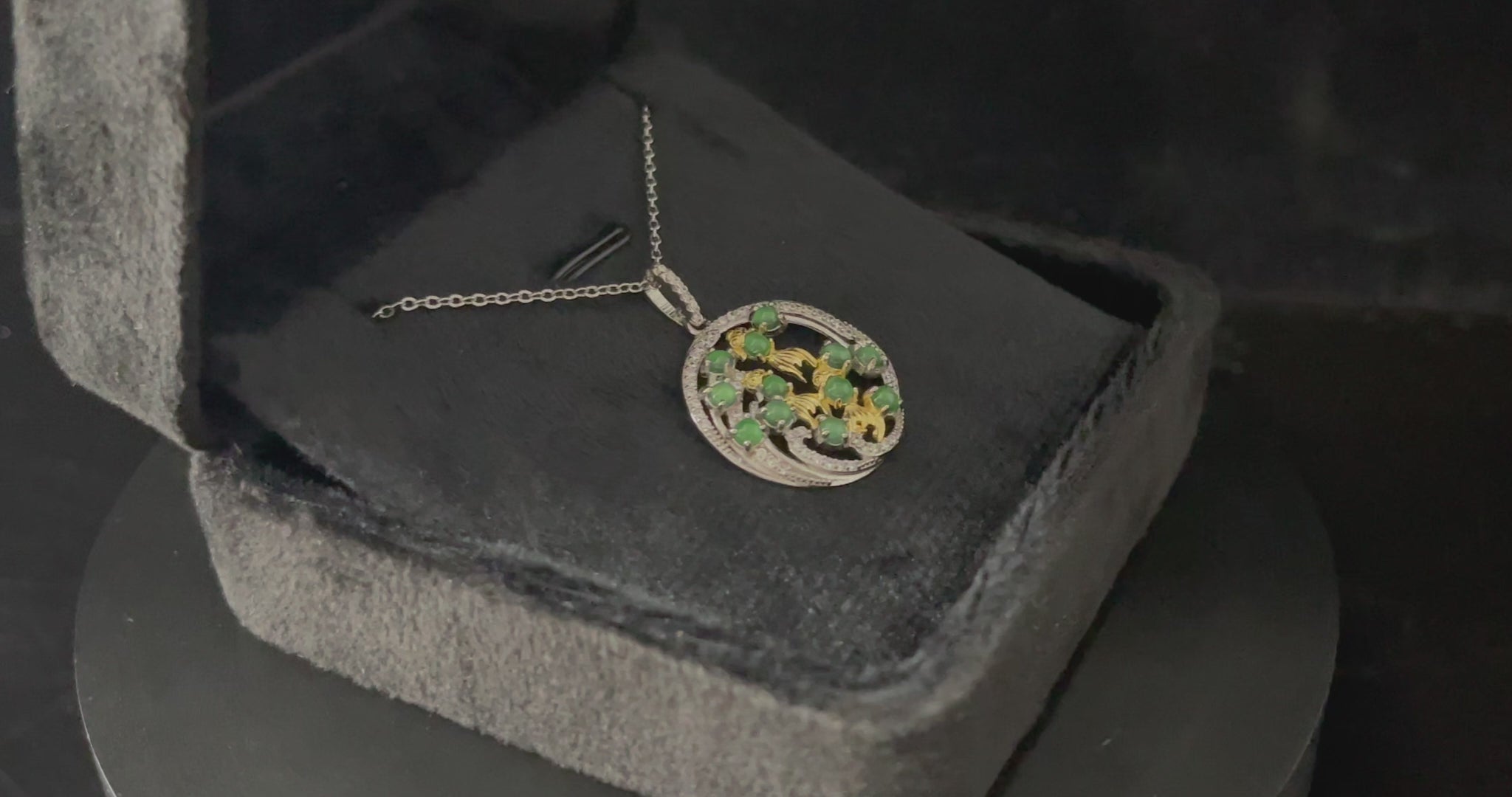 A green koi wreath jadeite pendant.