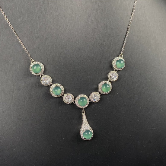 A lush green teardrop jadeite pendant.