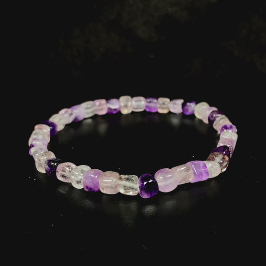 A mixed purple and clear tones crystal beads bracelet.