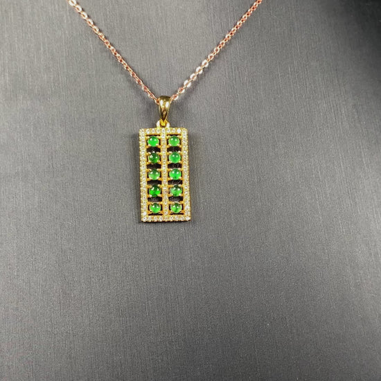 A full green square grid jadeite pendant.