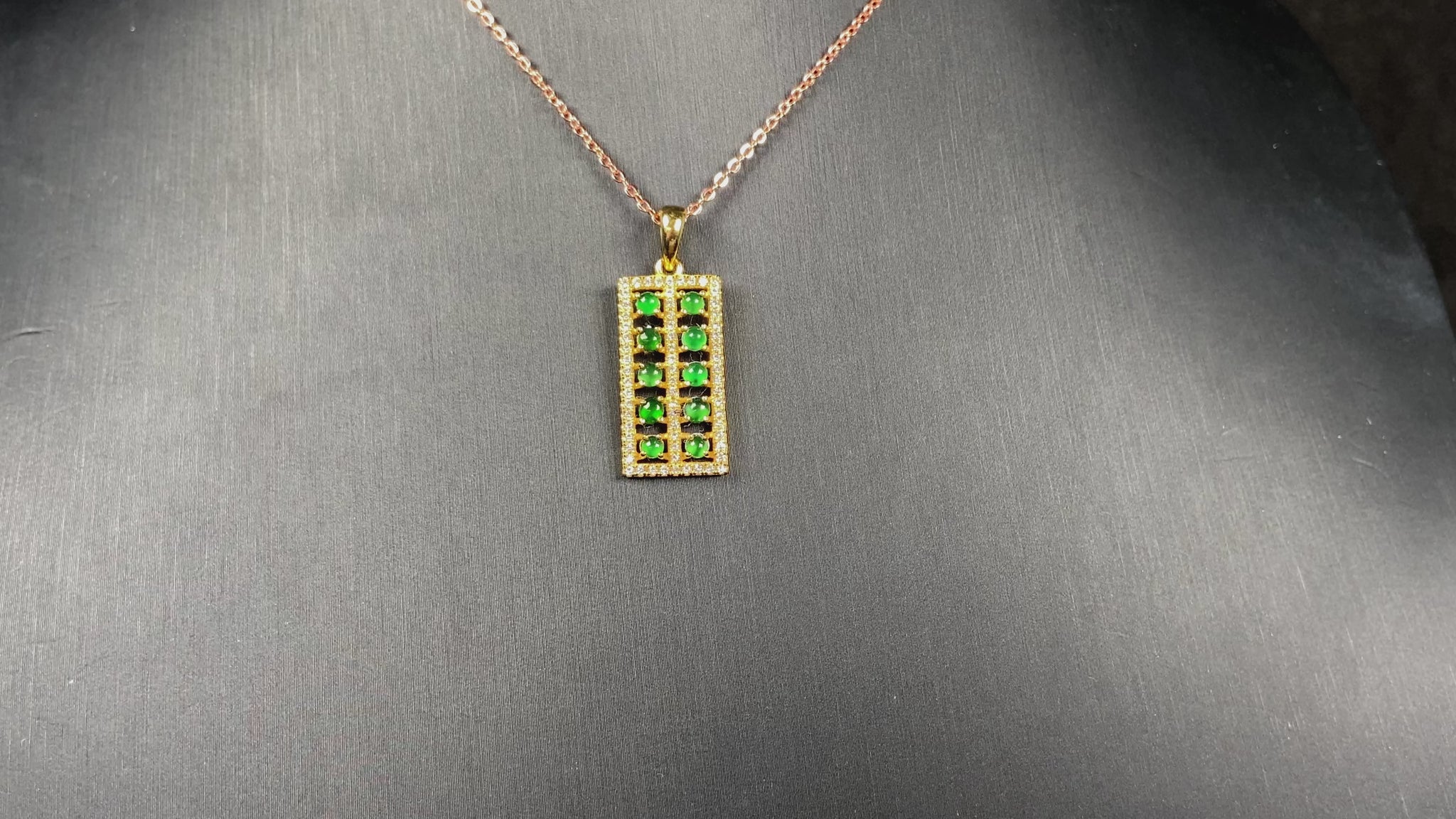 A full green square grid jadeite pendant.