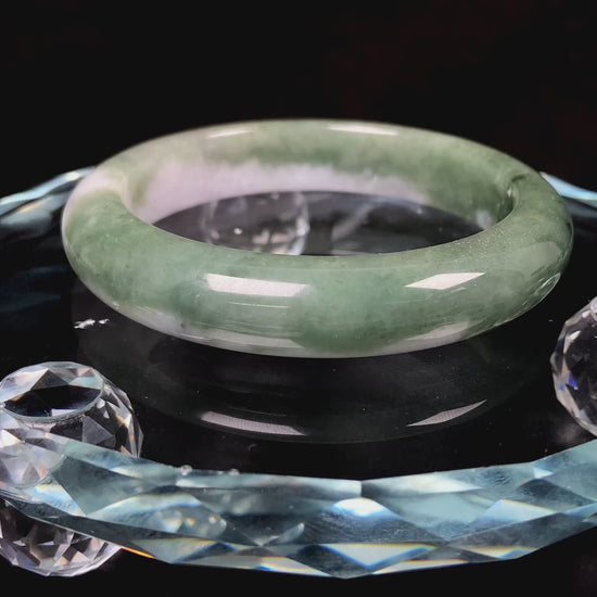 A oily deep green jadeite bangle.
