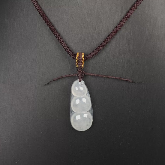 A pale green and icy white lucky pea pod jadeite pendant