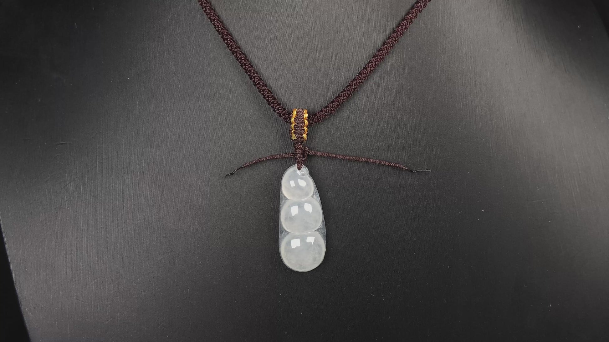 A pale green and icy white lucky pea pod jadeite pendant