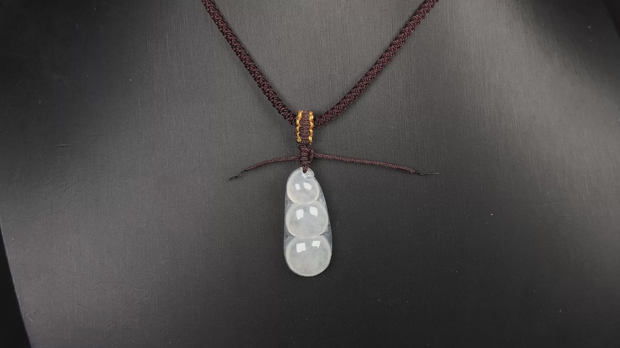 A pale green and icy white lucky pea pod jadeite pendant