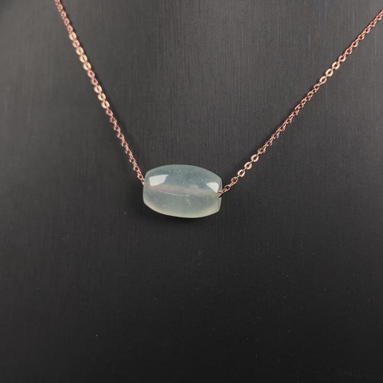A translucent pale aqua Lu Lu Tong jadeite pendant.