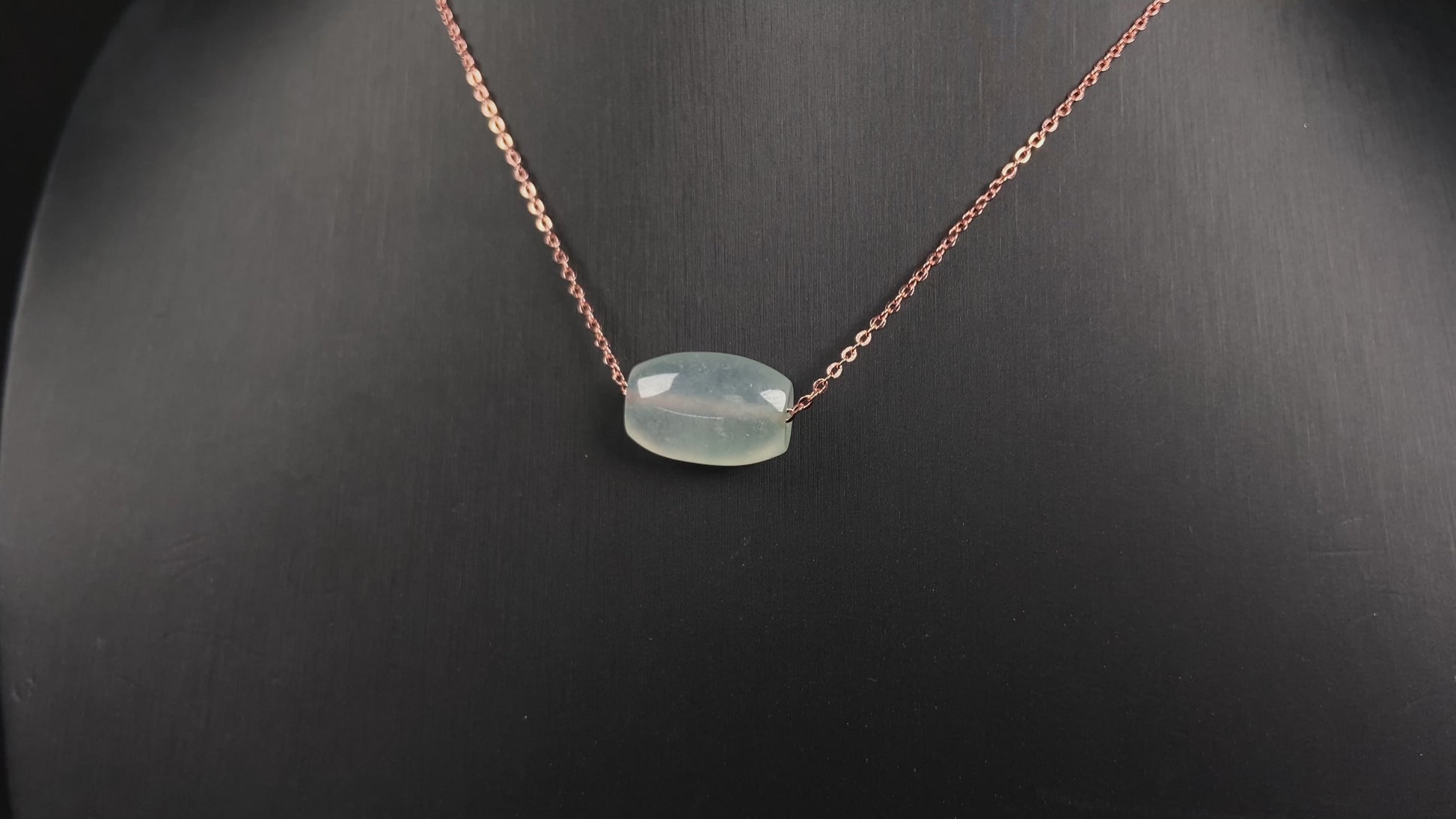 A translucent pale aqua Lu Lu Tong jadeite pendant.