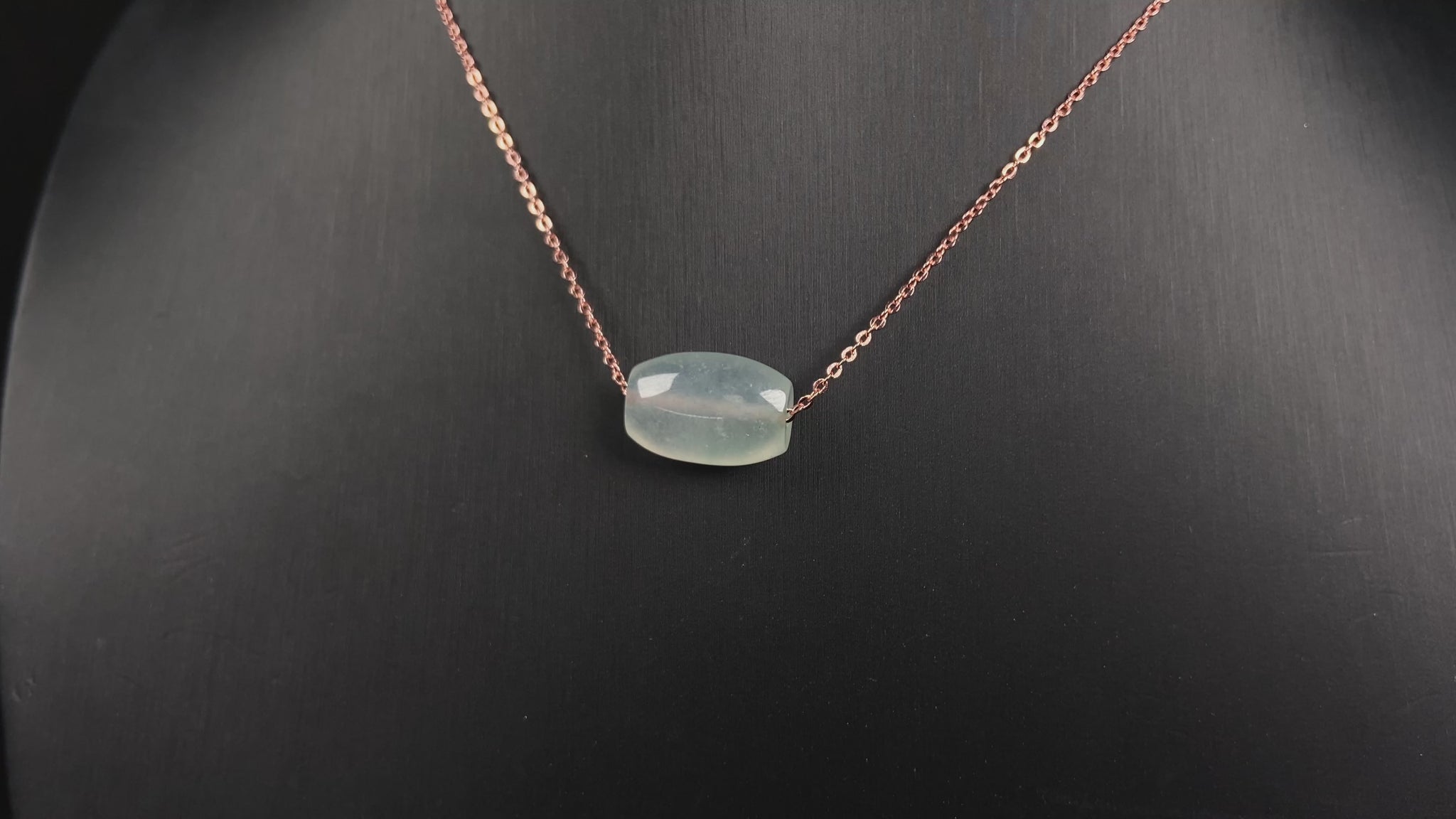 A translucent pale aqua Lu Lu Tong jadeite pendant.