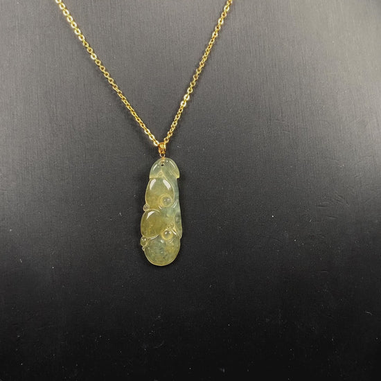 A honey yellow ruyi jadeite pendant.