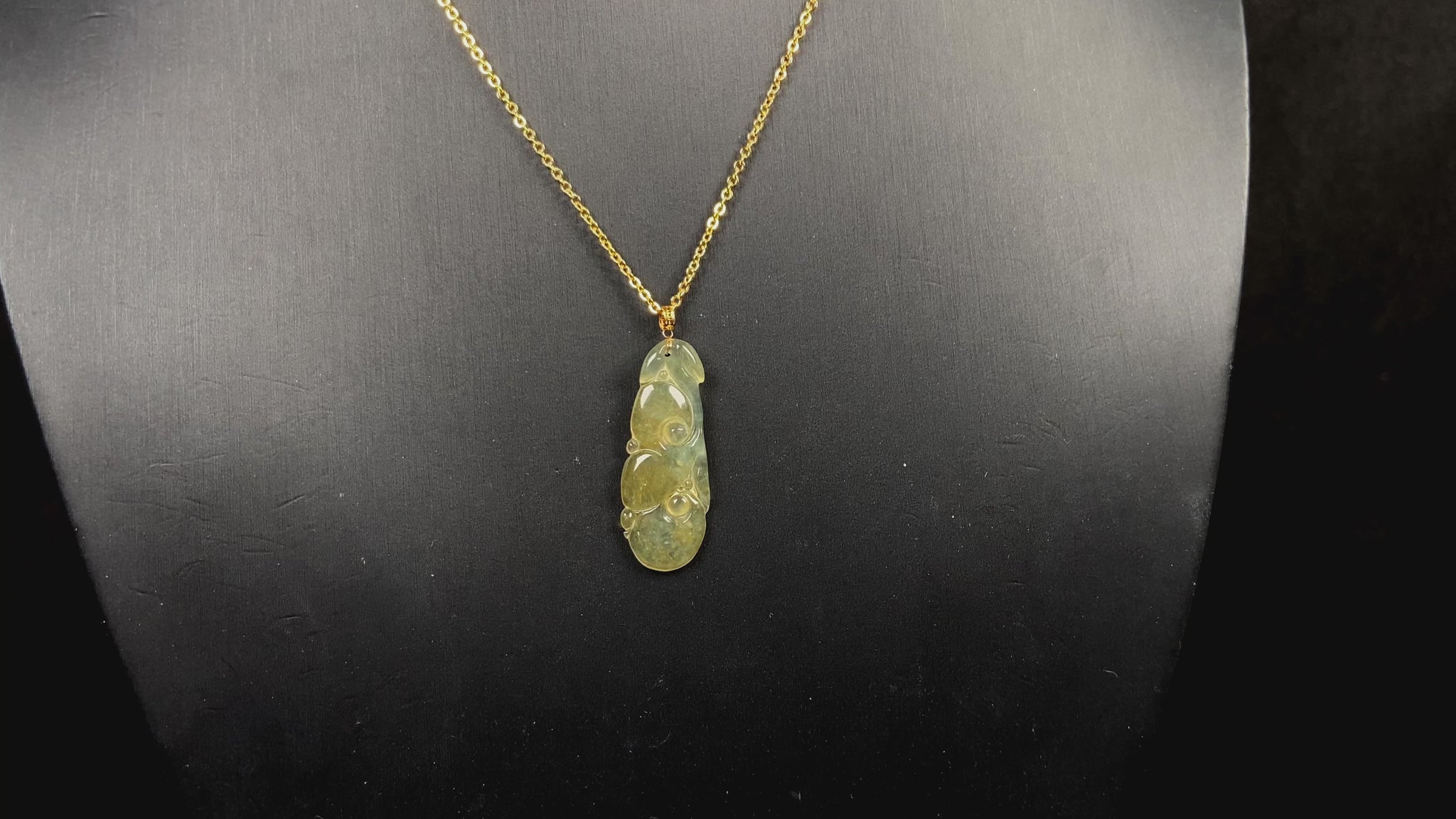 A honey yellow ruyi jadeite pendant.
