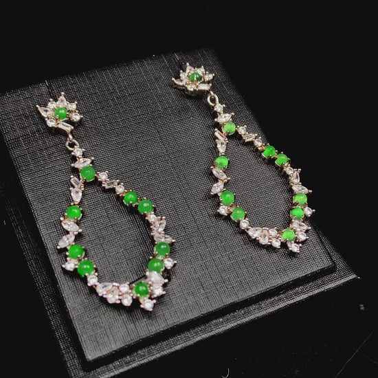 A green teardrop garland jadeite earrings.