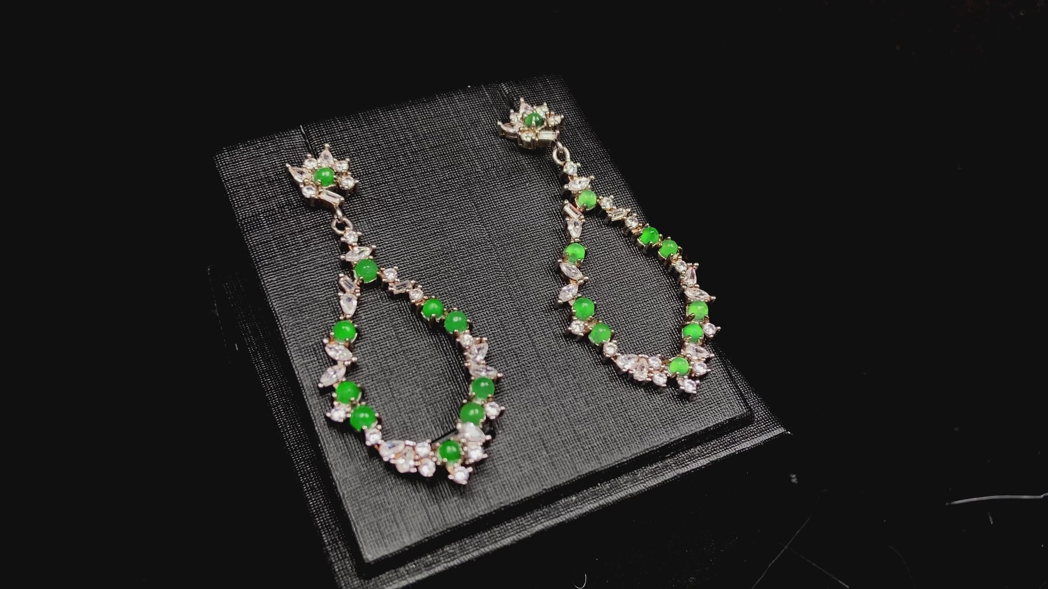 A green teardrop garland jadeite earrings.