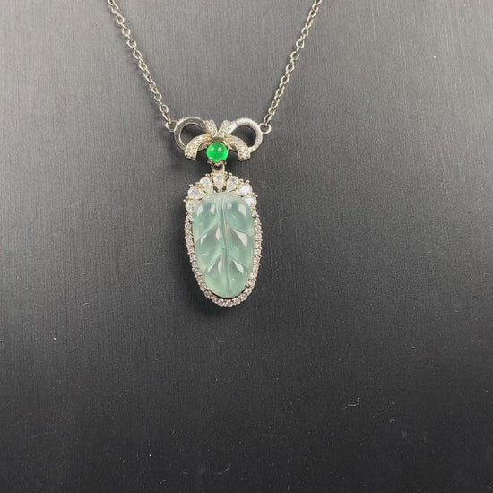 A lucky leaf with green bead jadeite pendant.