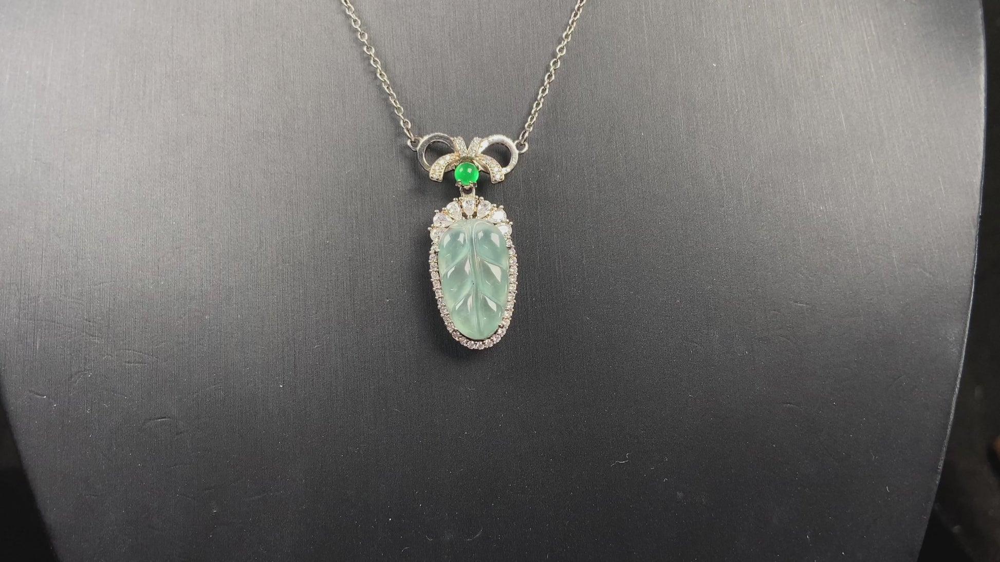 A lucky leaf with green bead jadeite pendant.