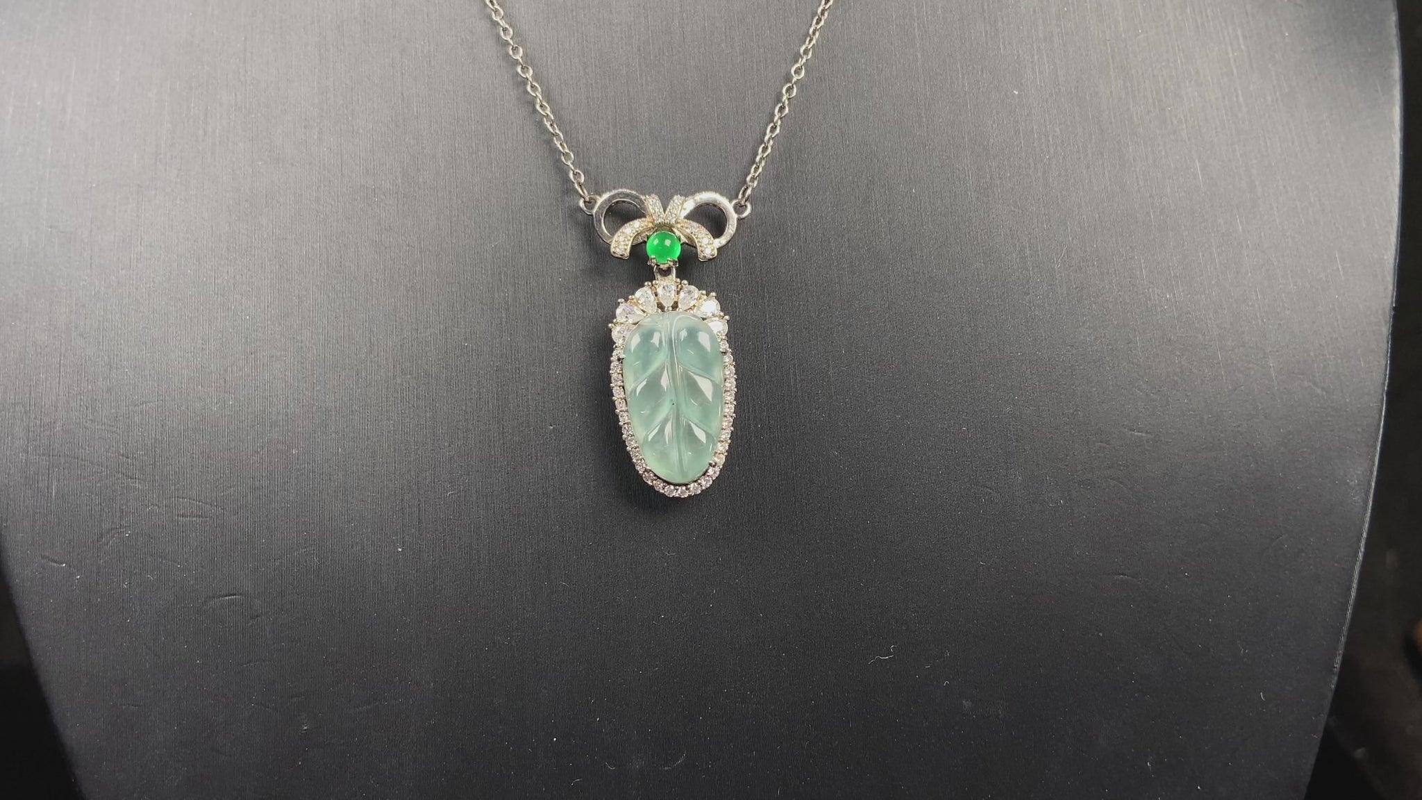 A lucky leaf with green bead jadeite pendant.
